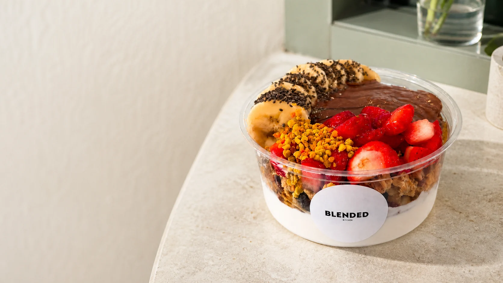 A smoothie bowl with fruit, granola and chocolate