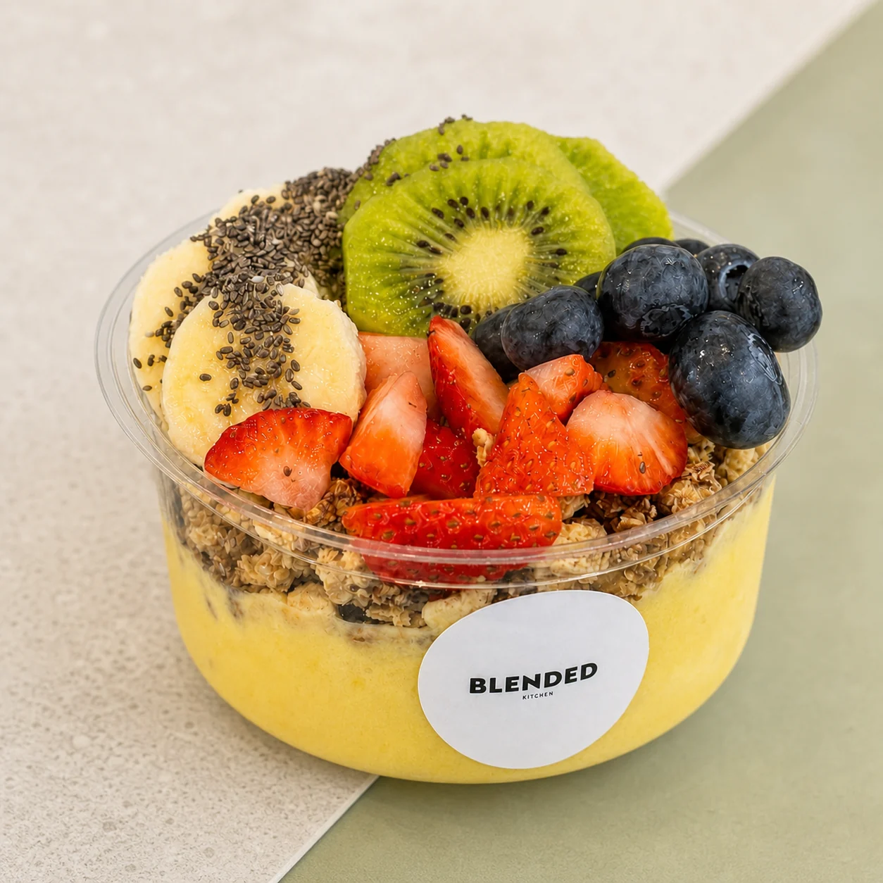 A tropical smoothie bowl with kiwi and berries